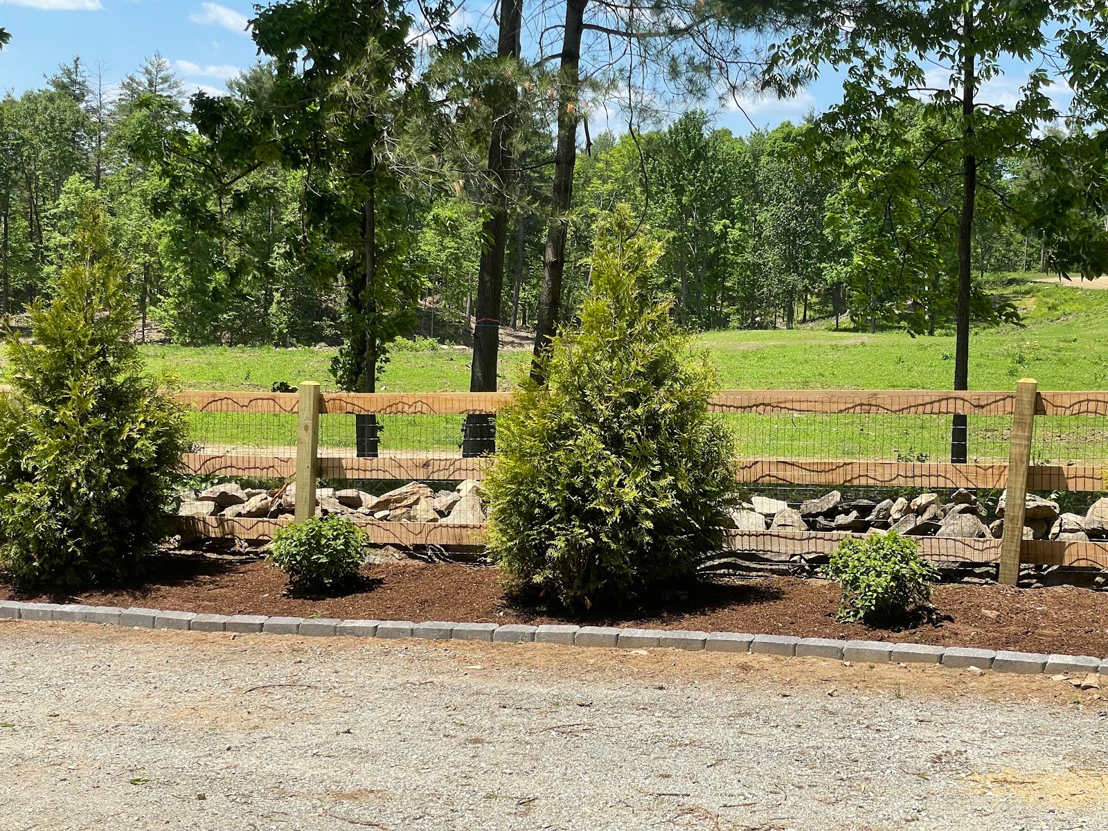 Black ornamental fence set behind fresh landscaping by 4 Fencework