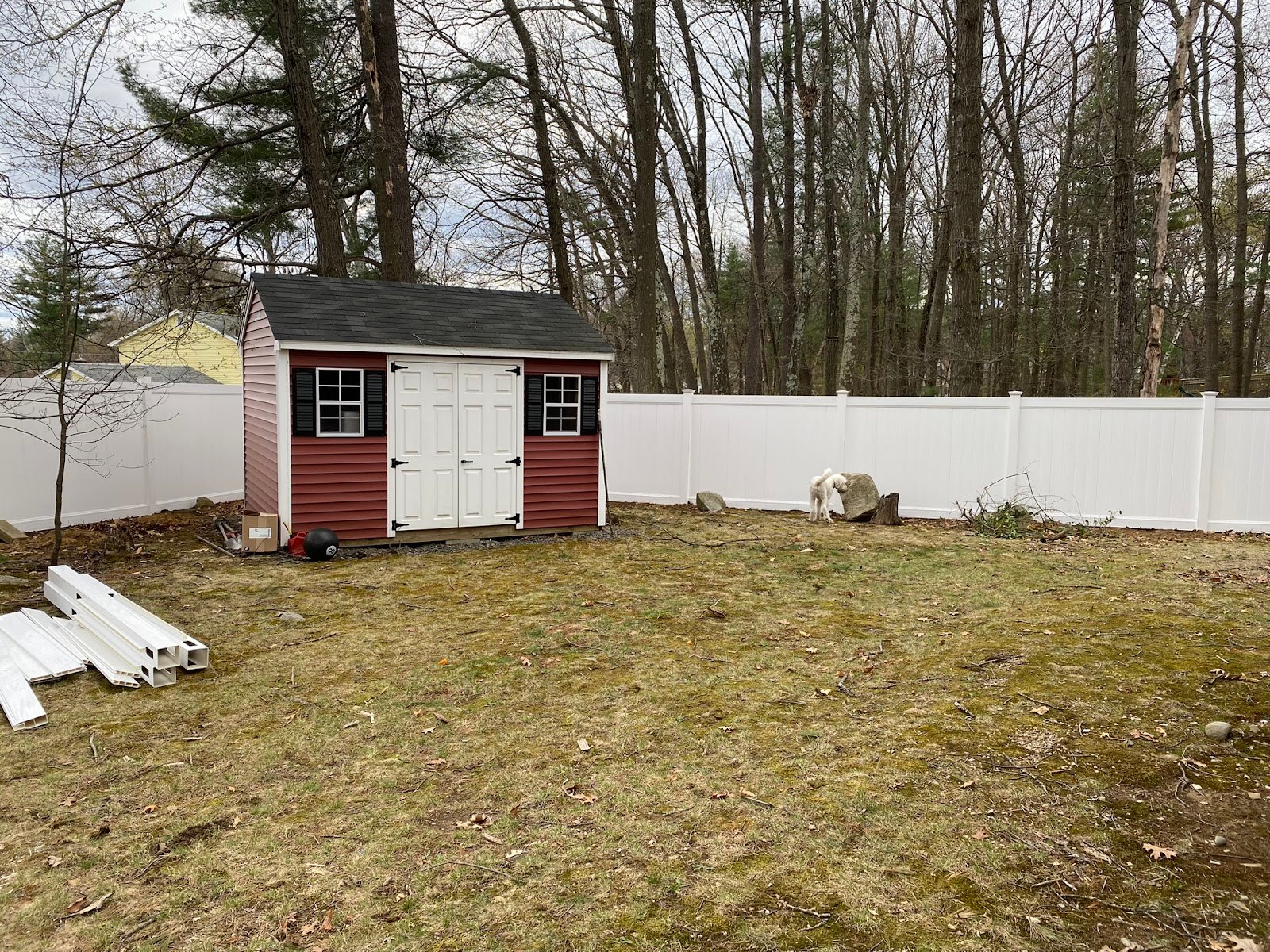 White vinyl privacy fence installed across a back yard by 4 Fencework